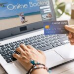 Young women planning summer vacation trip and searching information or booking hotel and using credit card on laptop, Travel concept