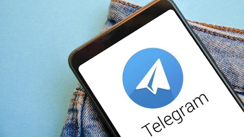 Telegram. Smartphone in the pocket of blue jeans on the Telegram smartphone screen on a blue, yellow, black background. Country in the smartphone Ukraine. July 2020. Kiev, Ukraine.