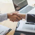 Greeting new colleagues, Handshake while job interviewing, male candidate shaking hands with Interviewer or employer after a job interview, employment and recruitment concept