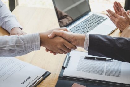 Greeting new colleagues, Handshake while job interviewing, male candidate shaking hands with Interviewer or employer after a job interview, employment and recruitment concept