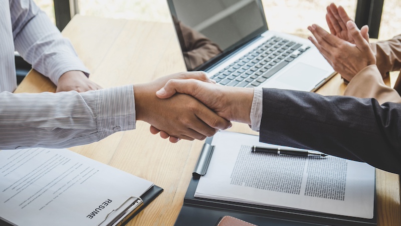 Greeting new colleagues, Handshake while job interviewing, male candidate shaking hands with Interviewer or employer after a job interview, employment and recruitment concept